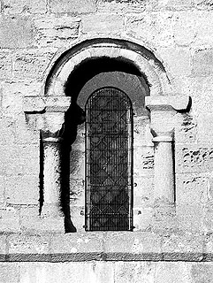 one of the norman chancel windows, almost vanishing into the wall surrounding it