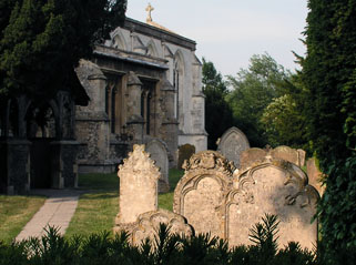 the locked graveyard and the enticing chancel beyond gravestones in early summer sunlight